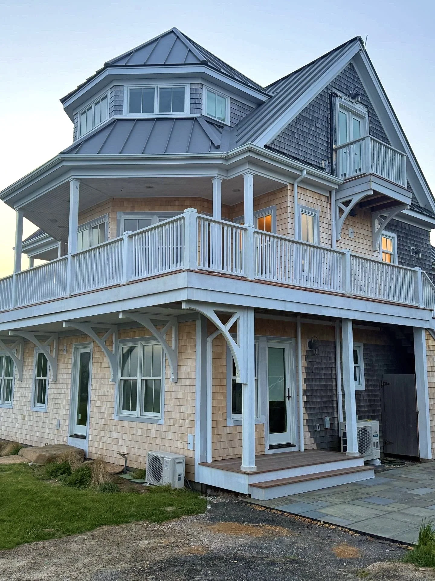 Custom fabricated paint grade western red cedar rails with mahogany balusters with mahogany herringbone deck on Block Island RI Mohegan bluffs 
