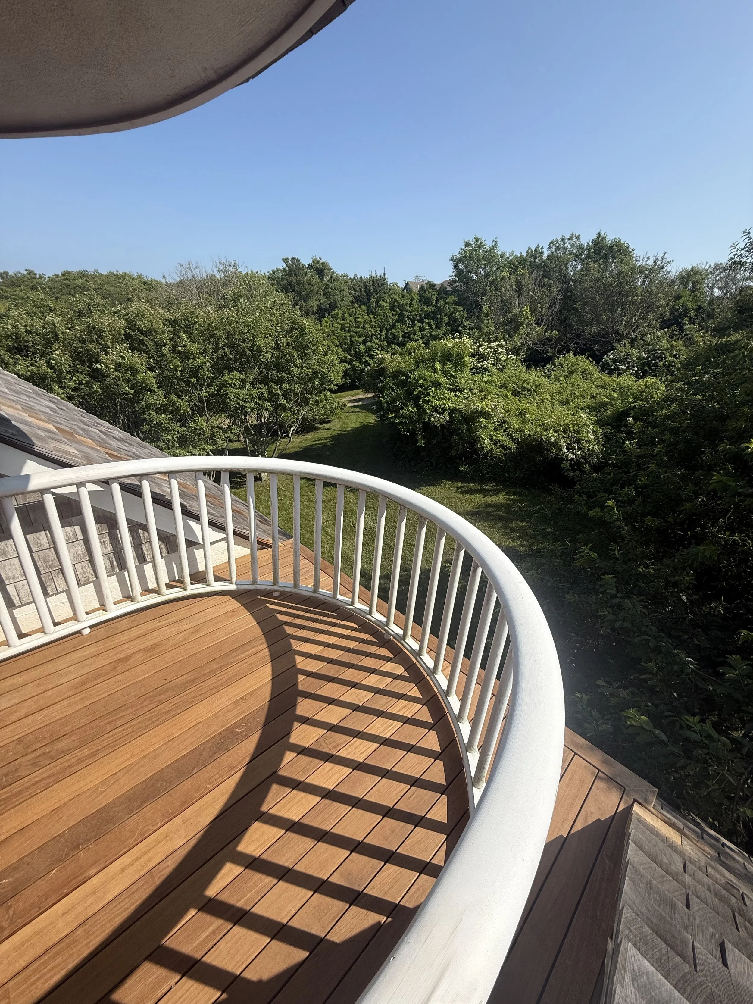 Ipe narrow board deck balcony on an Owen's Corning OC Lumber frame with custom curved mahogany hand rails on Block Island RI