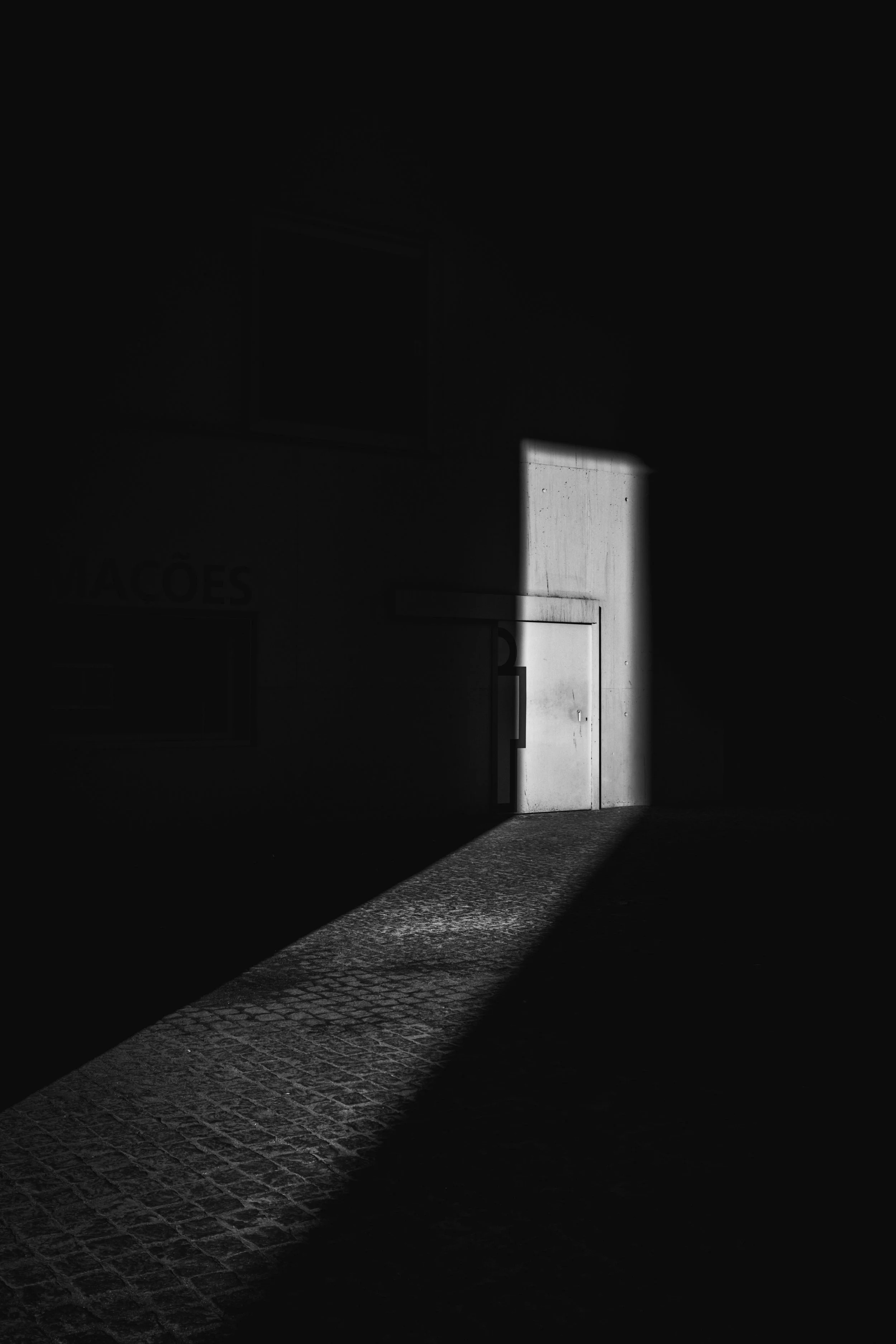 Dark, atmospheric alley way, sliver of light on a door