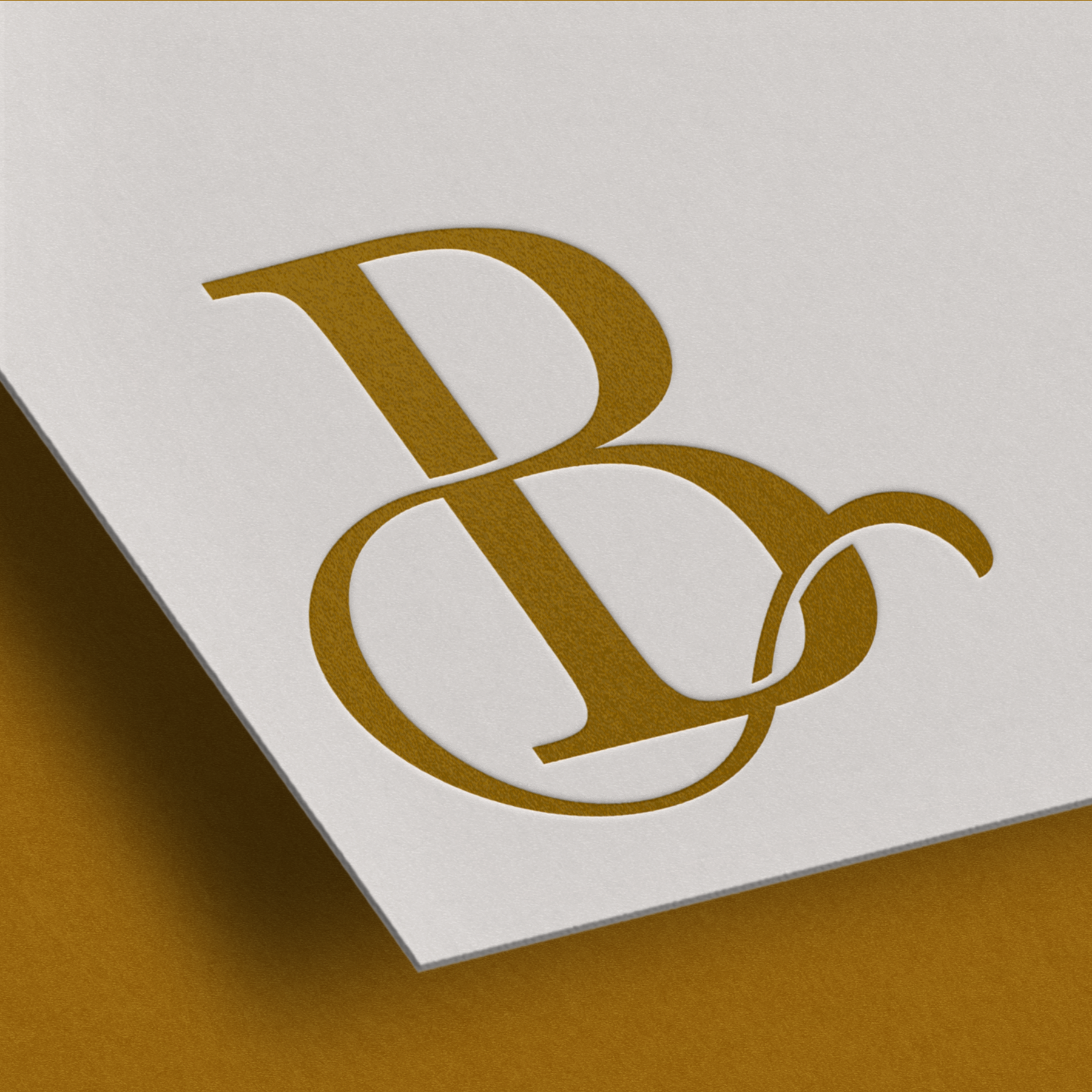 B monogram logo printed in yellow-brown ink hovering over mustard background