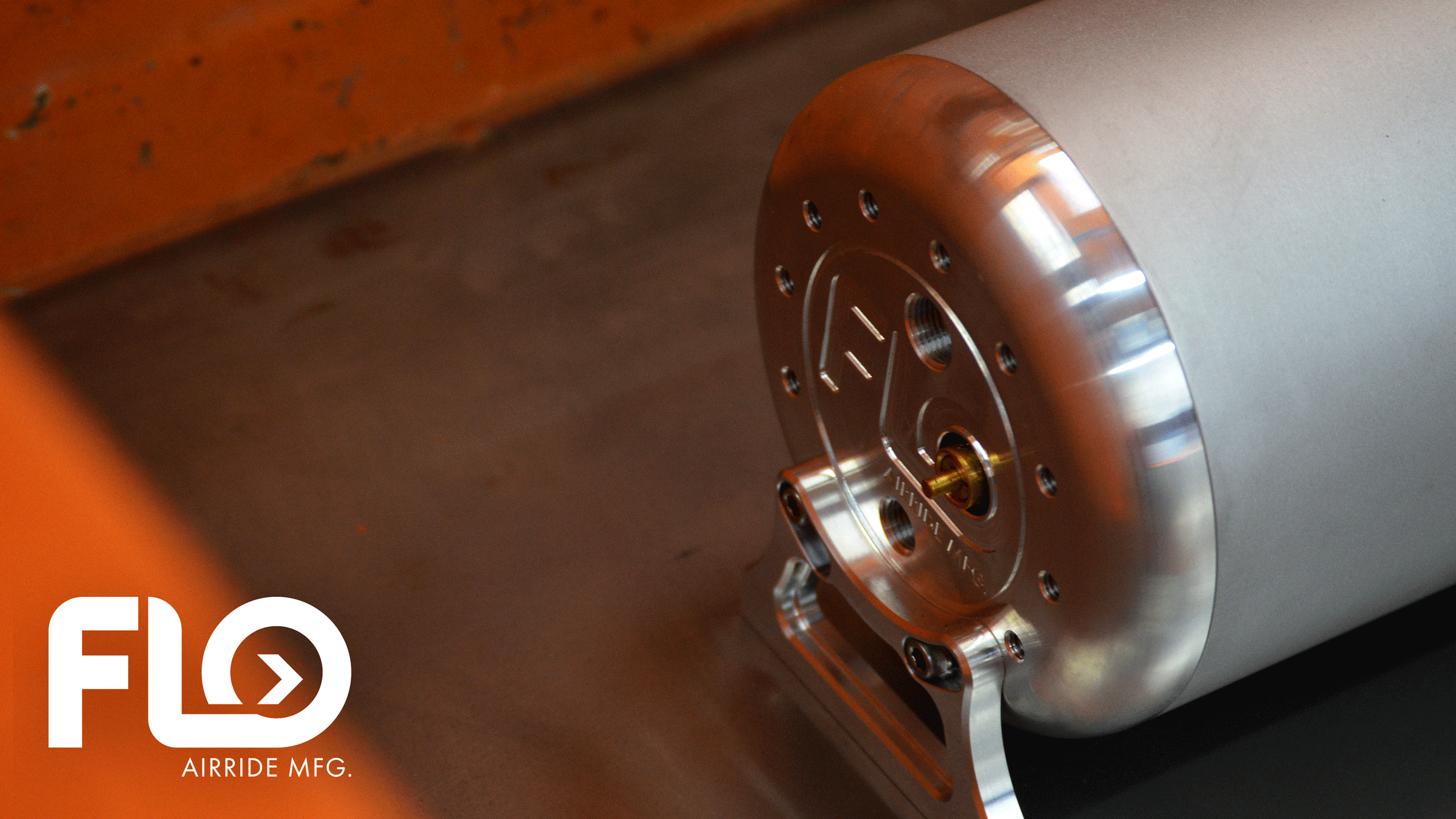 detailed shot of FLO Airride tank placed on the wood deck of an orange show truck