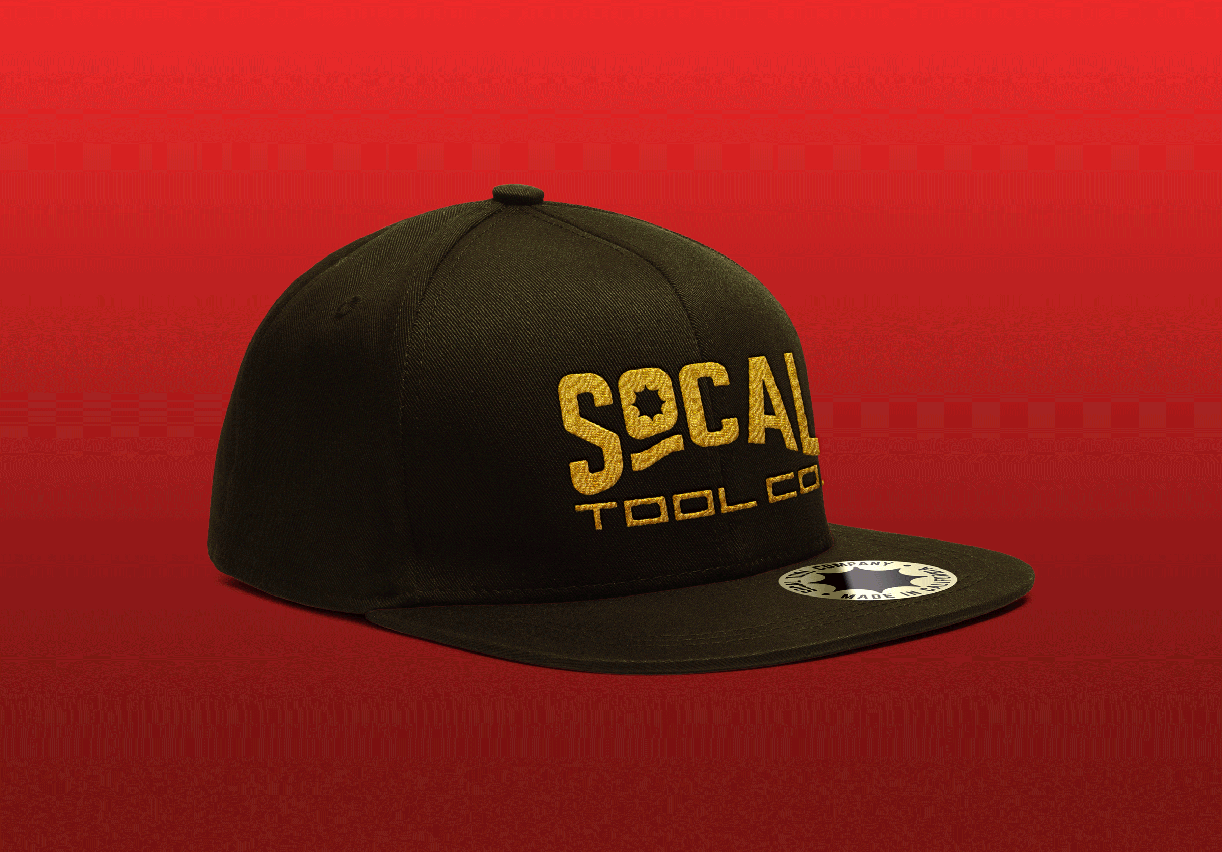 Brown hat embroidered with the SoCal Tool Co. logo in gold thread, placed over a red gradient background