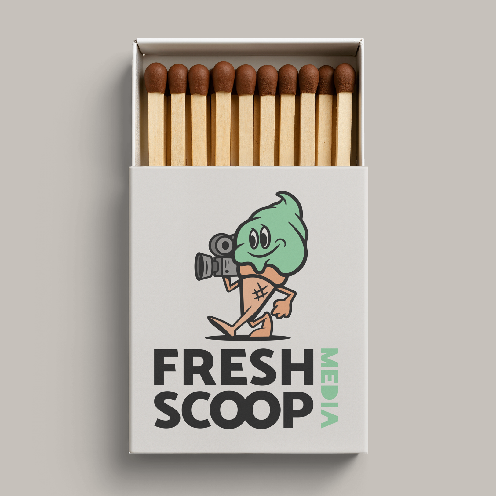 Custom printed matchstick box showing Fresh Scoop Media mascot logo and branding