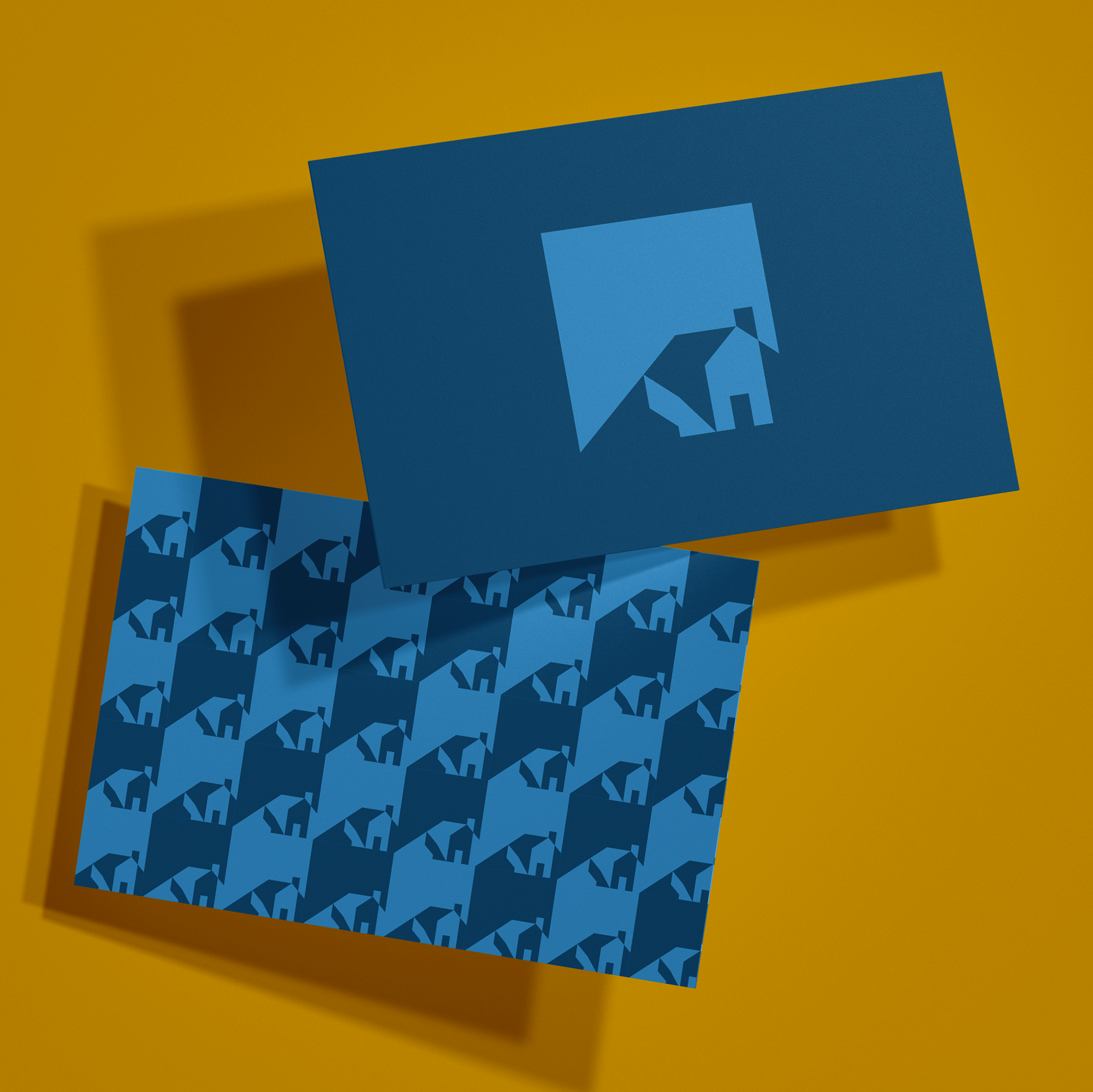 Stone House logo and logo pattern printed in blue shades on business cards over a yellow background