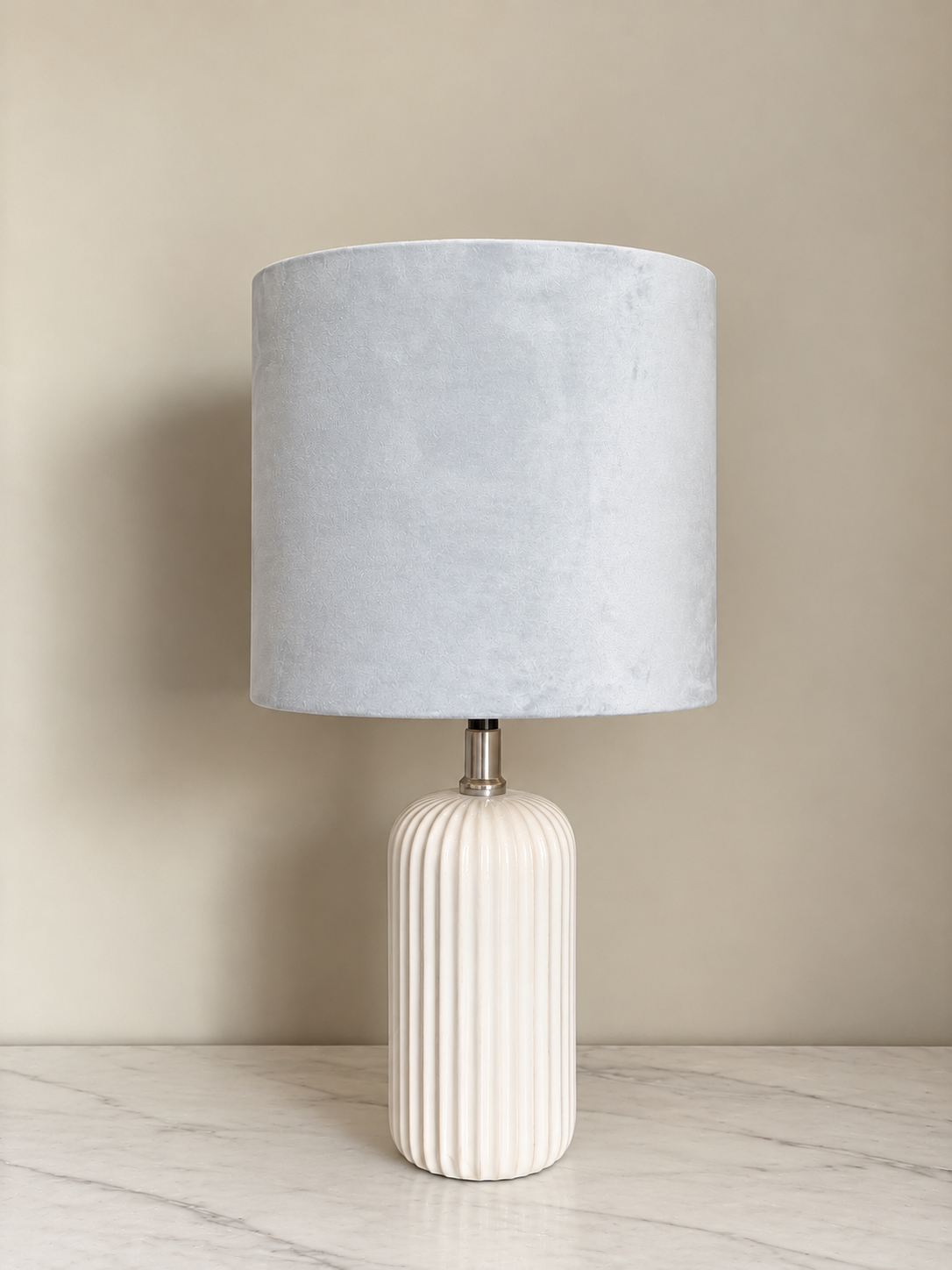 Ribbed Ceramic Lamp on Marble Surface.png