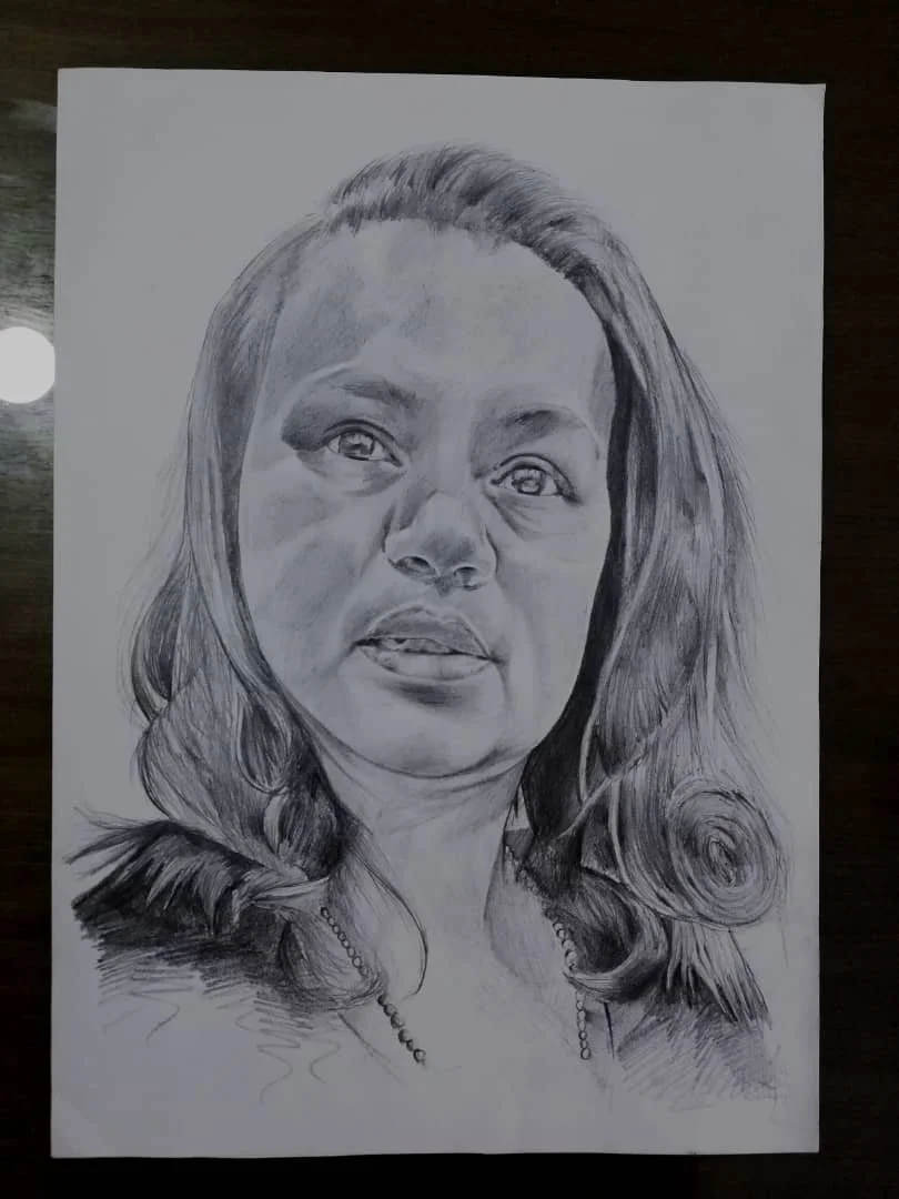 A detailed pencil sketch of a woman with long, wavy hair wearing a necklace.
