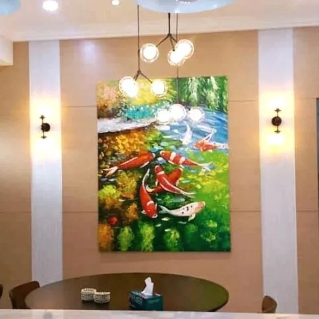 Colorful painting of koi fish swimming in a pond with greenery in the background.