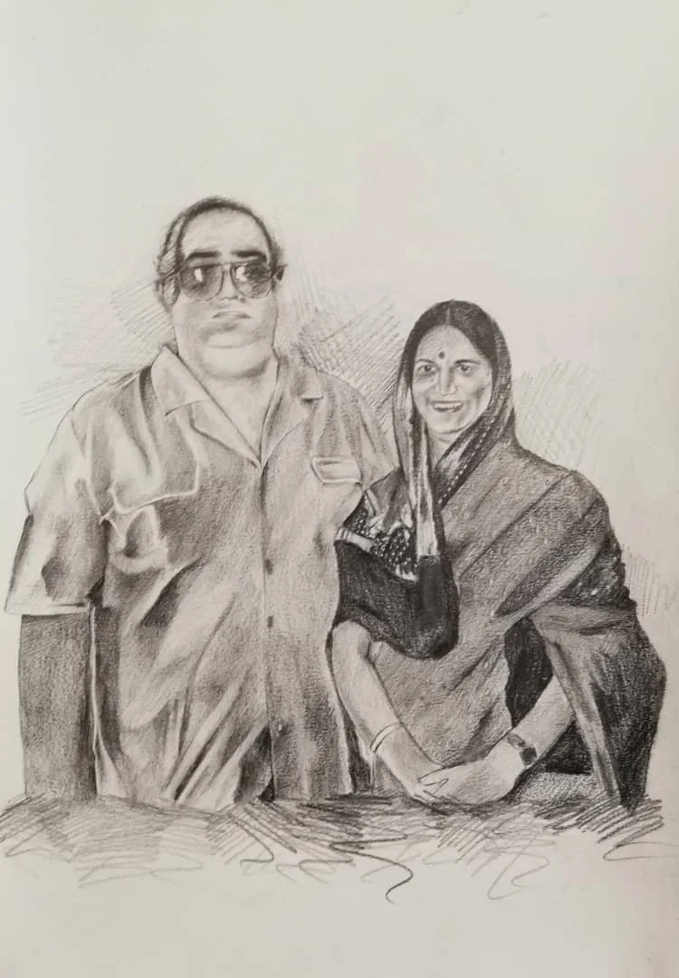 A pencil sketch of a man and woman standing side by side, smiling. The man wears sunglasses and a short-sleeved shirt, while the woman is dressed in traditional Indian attire and a sari.