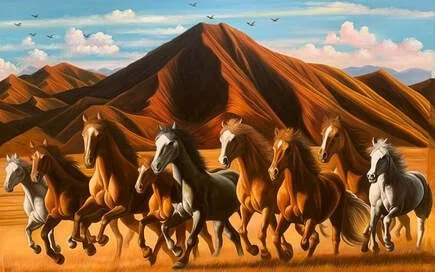 A group of horses running across a desert landscape with large mountains in the background.