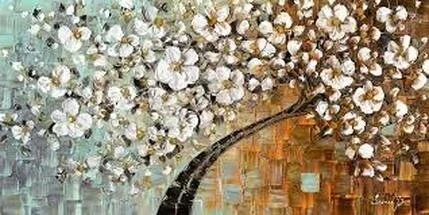 A bundle of white cotton flowers inside a glass vase on a wooden surface.