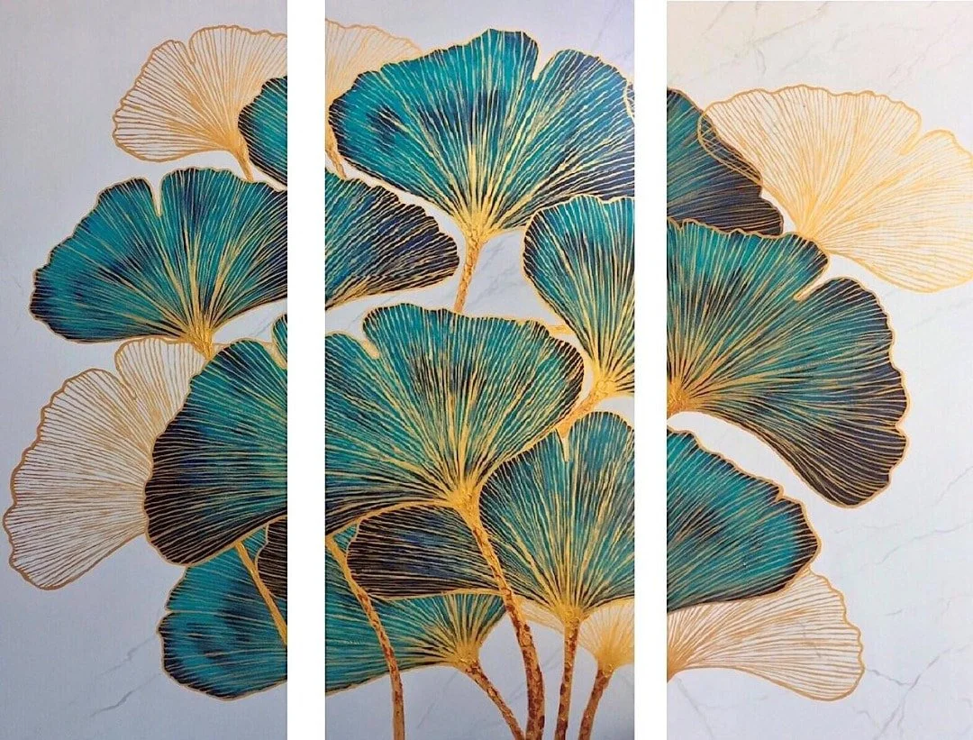 Decorative wall art depicting stylized ginkgo leaves in shades of blue, black, and gold, arranged in a triptych format.