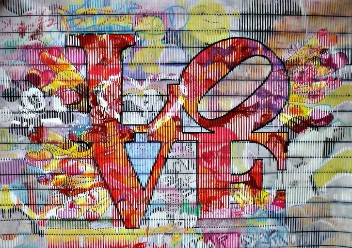 Graffiti mural featuring the word 'LOVE' with colorful abstract background and decorative hearts.
