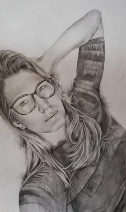 A black and white sketch of a young woman with glasses, long hair, and a striped shirt, lying down with one arm behind her head.