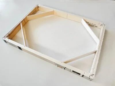 Empty wooden frame on a white surface