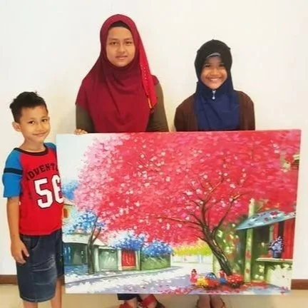 Three children holding a colorful painting of a cherry blossom tree in a park.