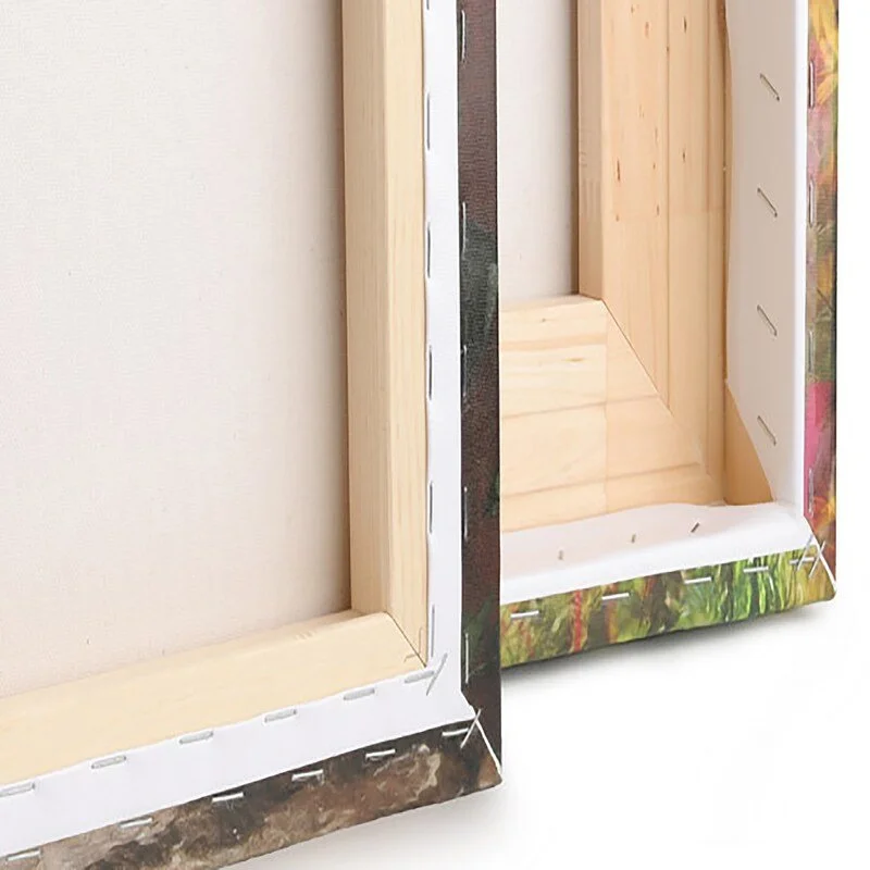 Close-up of the inside corners of two wooden picture frames, one with a colorful floral border.