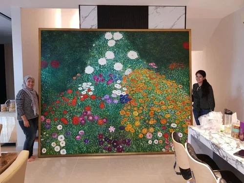 Two women standing beside a large colorful floral painting in an indoor setting.