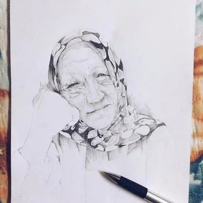 A pencil sketch of an elderly woman wearing a headscarf, with some facial features and details partially drawn.