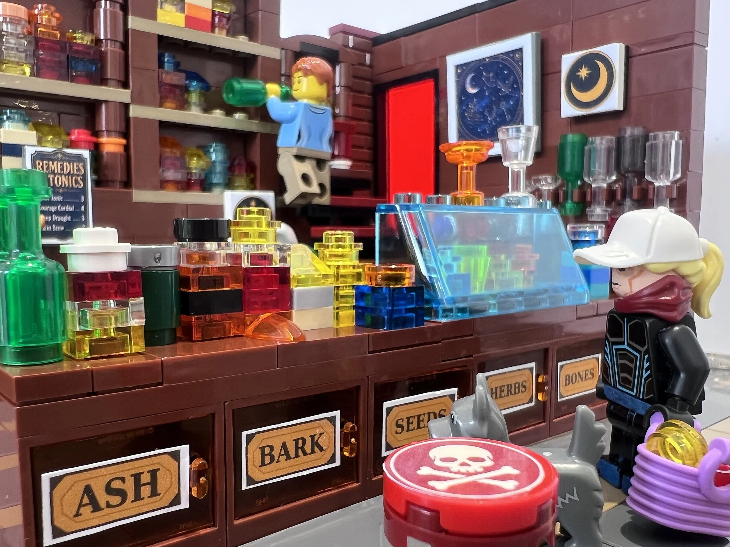 LEGO apothecary counter with ingredient drawers labelled Ash, Bark, Seeds, Herbs and Bones