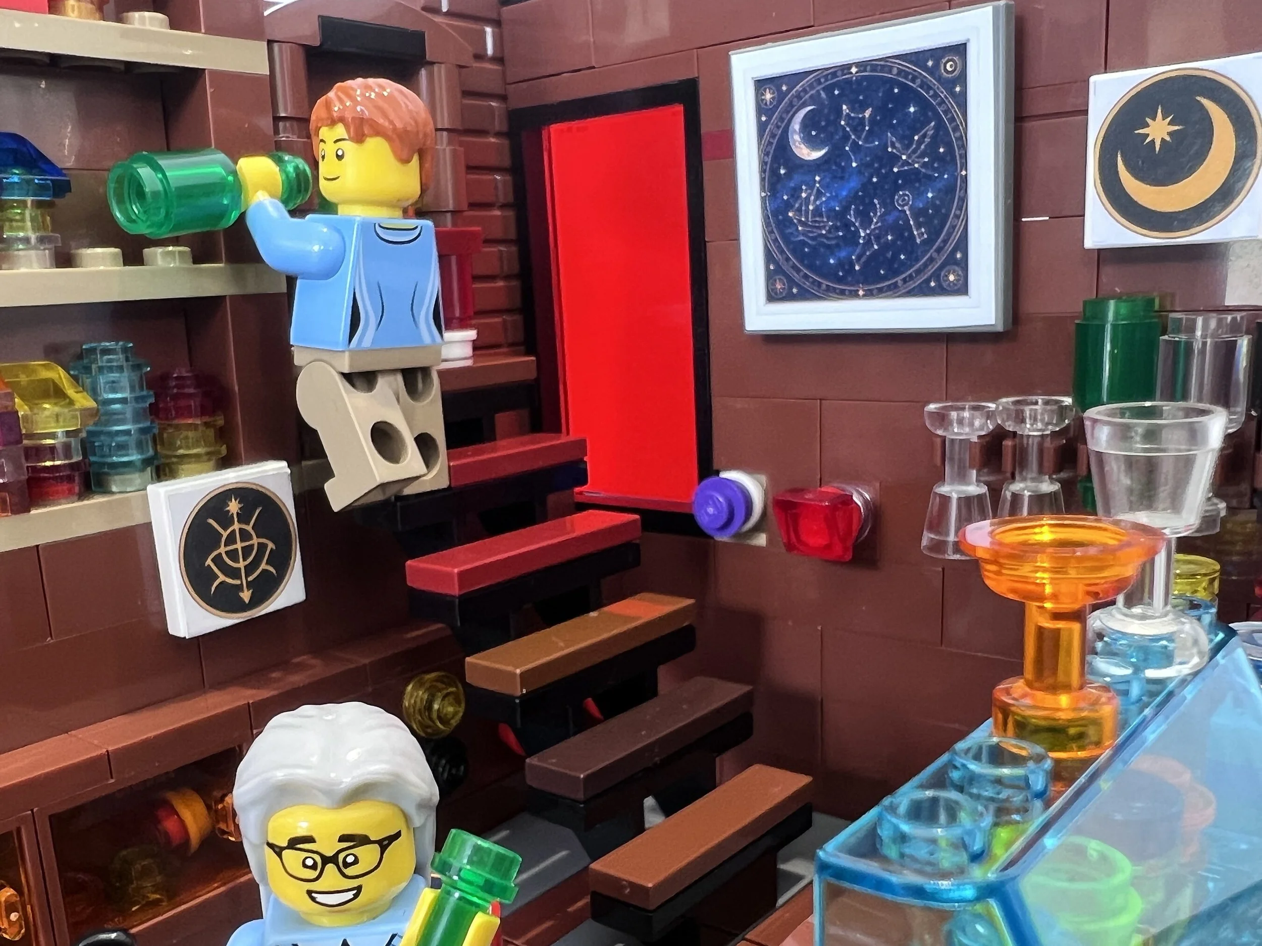 LEGO apothecary wall with a framed star chart and a moon and star tile sticker above the glassware