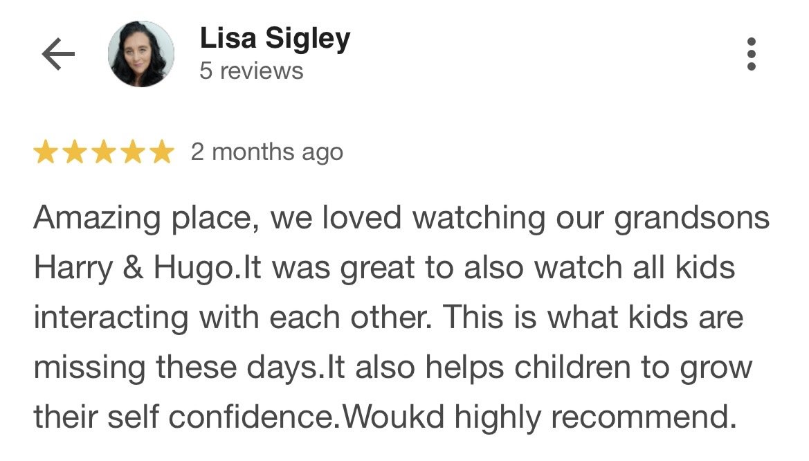 Screenshot of a Google review by Lisa Sigley, five stars, praising a place for kids' activities and interaction helping children grow confidence.