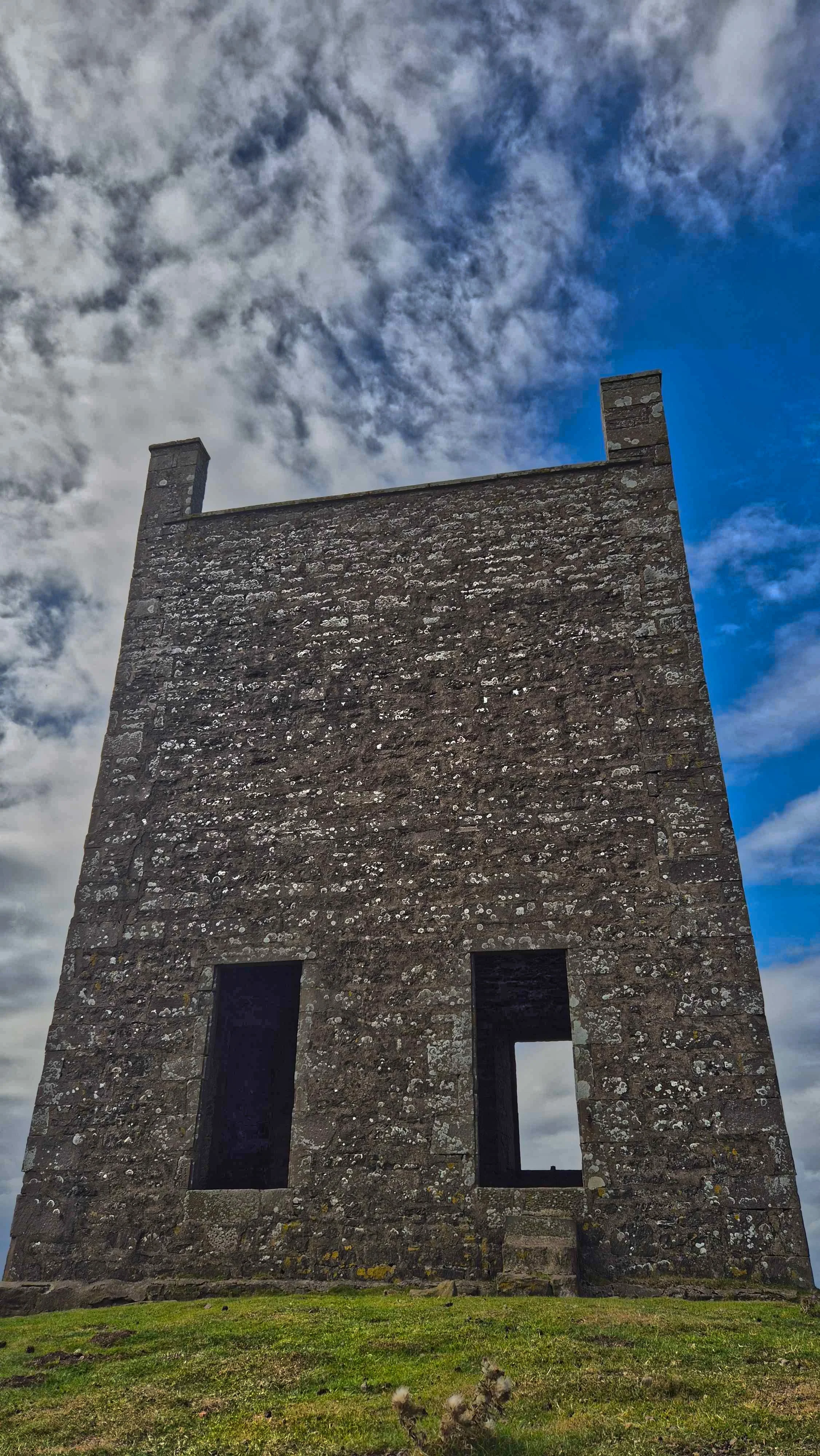 Historic stone monument structure set against a dramatic sky in the East of Scotland.