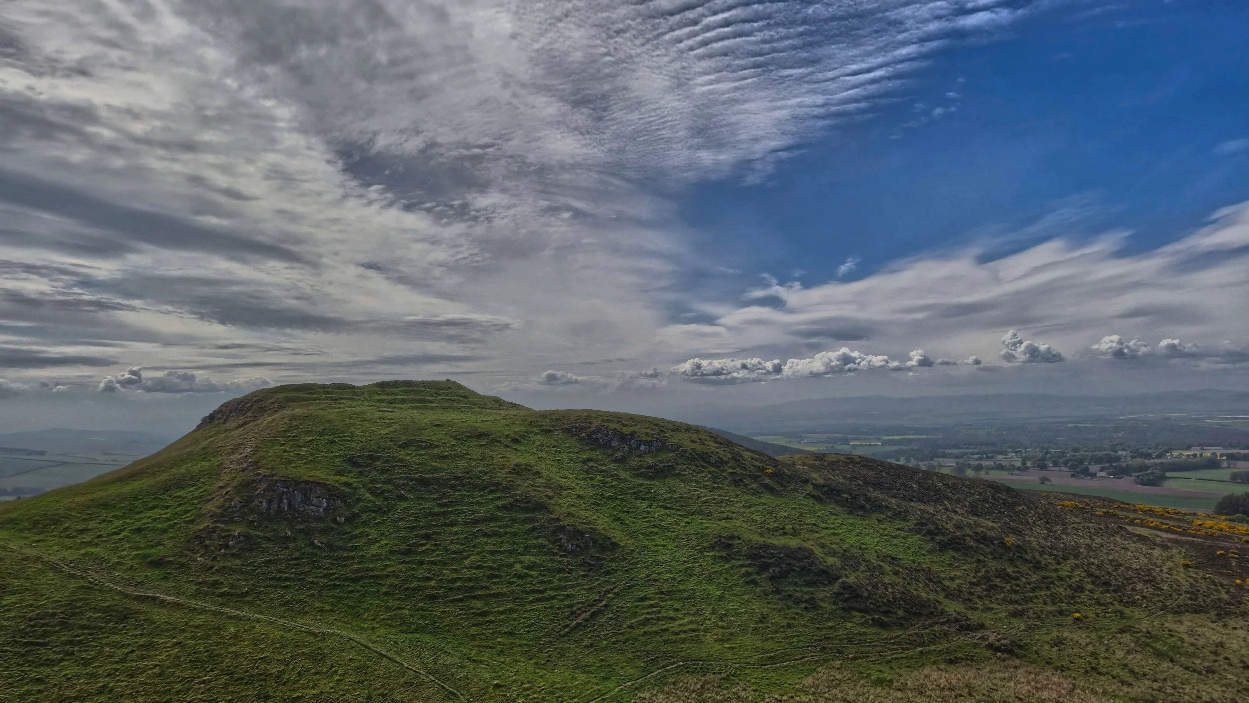 Fine art Scottish landscape photography capturing sweeping rolling hills under an expansive sky.