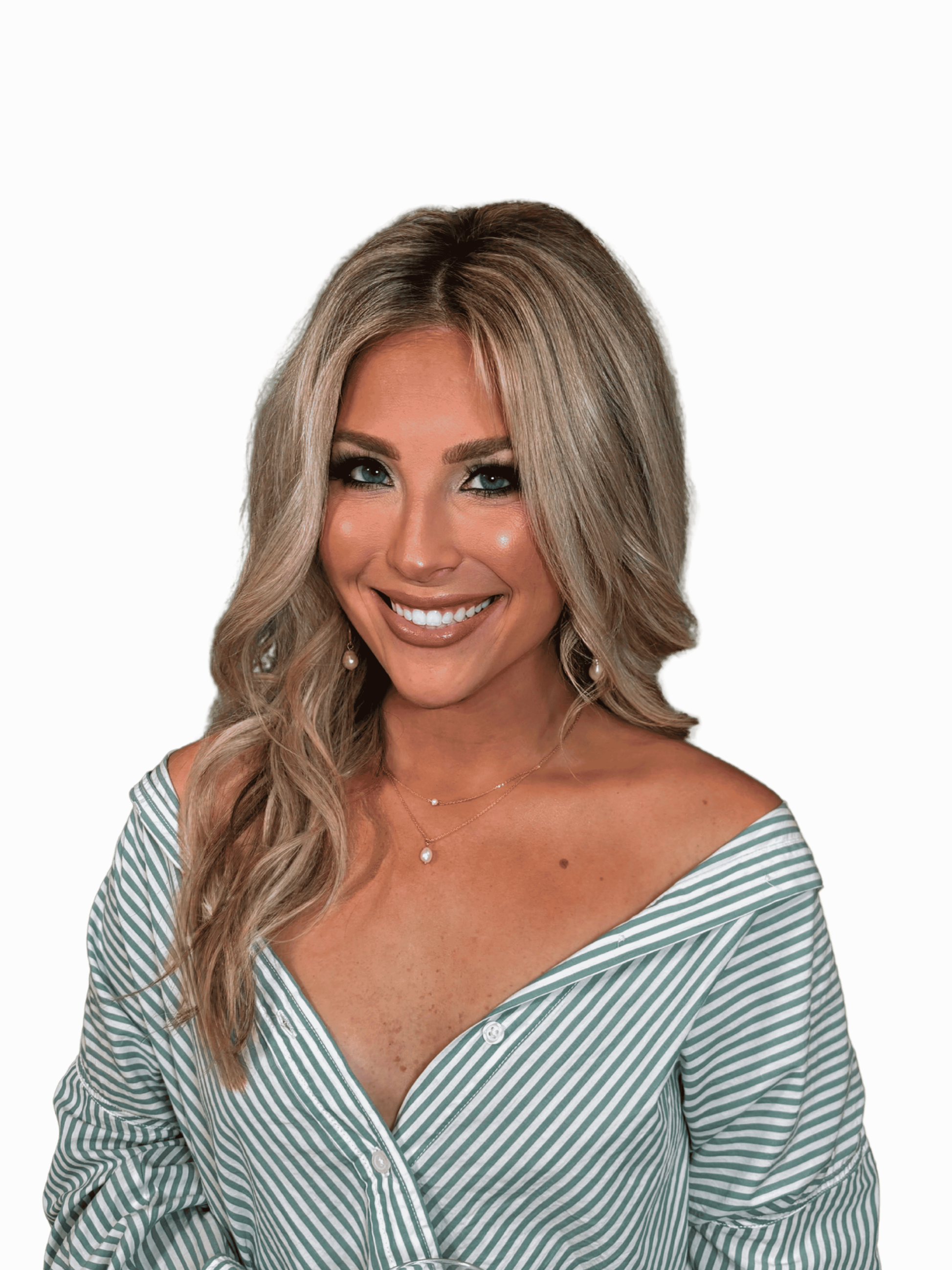 Close-up of a smiling woman with long, wavy blonde hair, wearing a green and white striped off-the-shoulder top, jewelry, and makeup, against a black background.