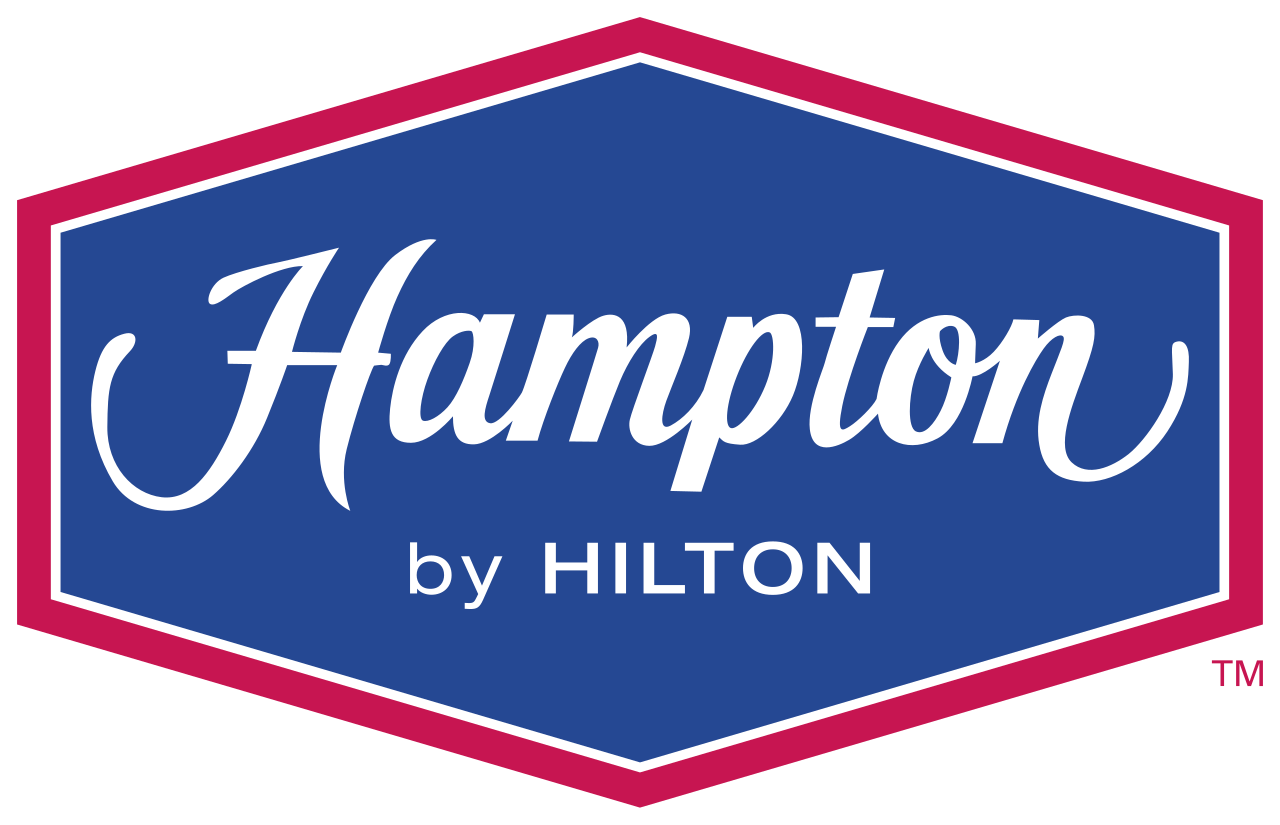 Logo for Hampton by Hilton hotel with a blue background and a border in red and white, featuring the word Hampton in cursive and by Hilton in capital letters.