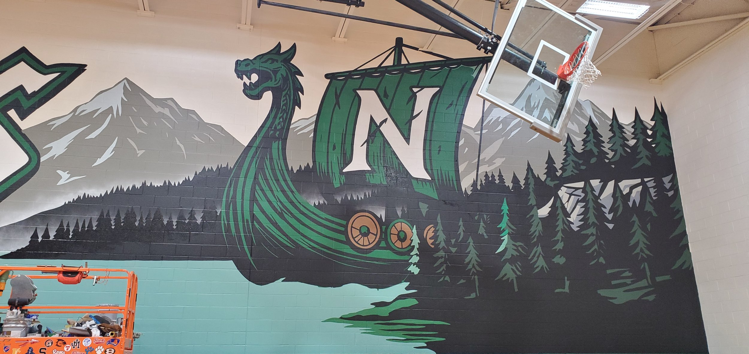 A mural depicting a Viking ship with a dragon head prow, surrounded by mountains and pine trees.