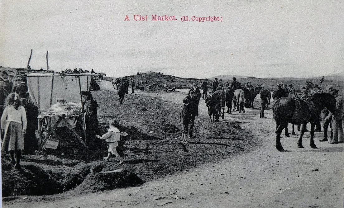 Black and white photo of a marketplace with people and horses, labeled 'A Uist Market' at the top.