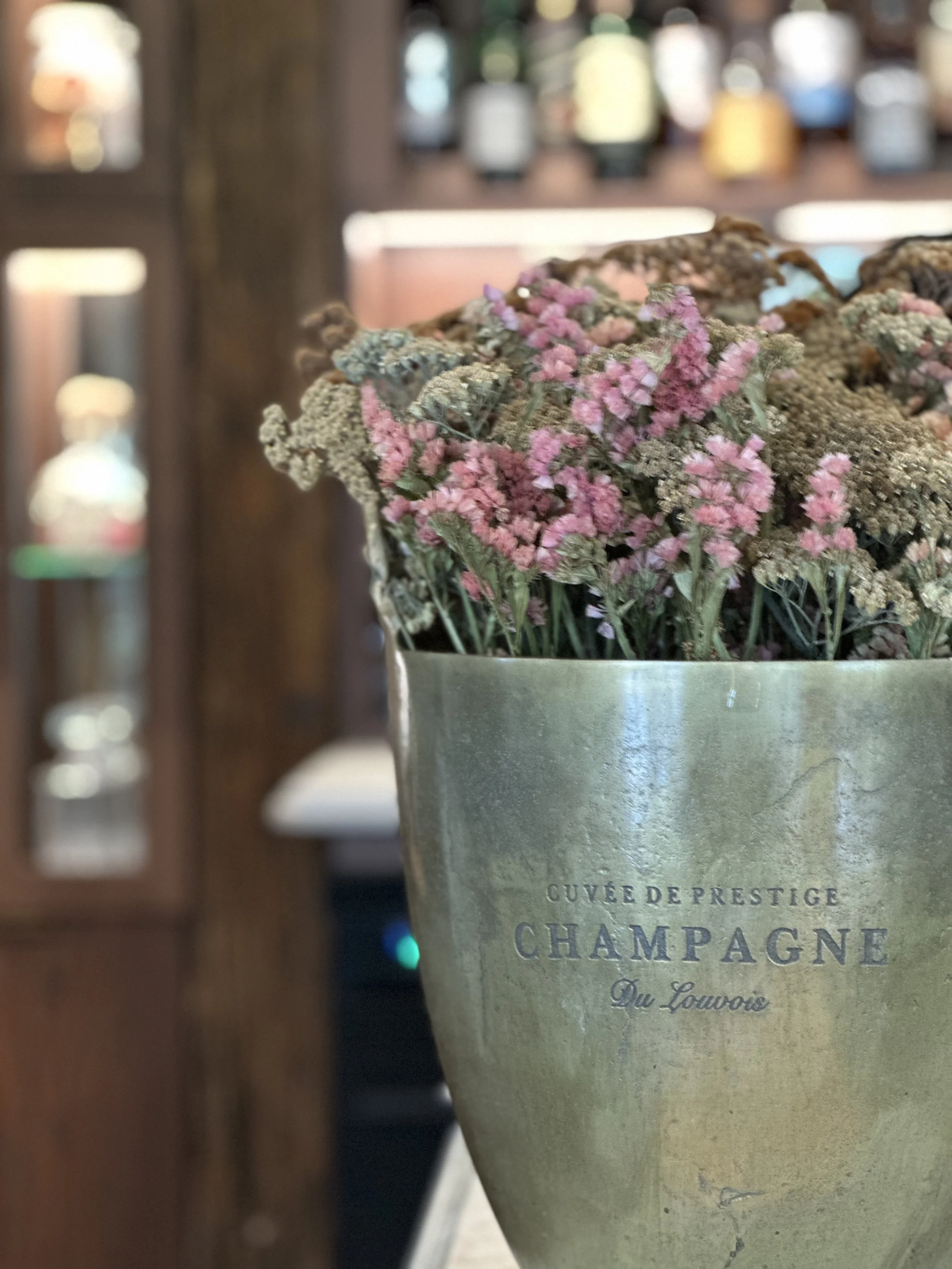 A metal Champagne bucket from Lusso Boutique filled with dried flowers from Dart Valley Station Queenstown