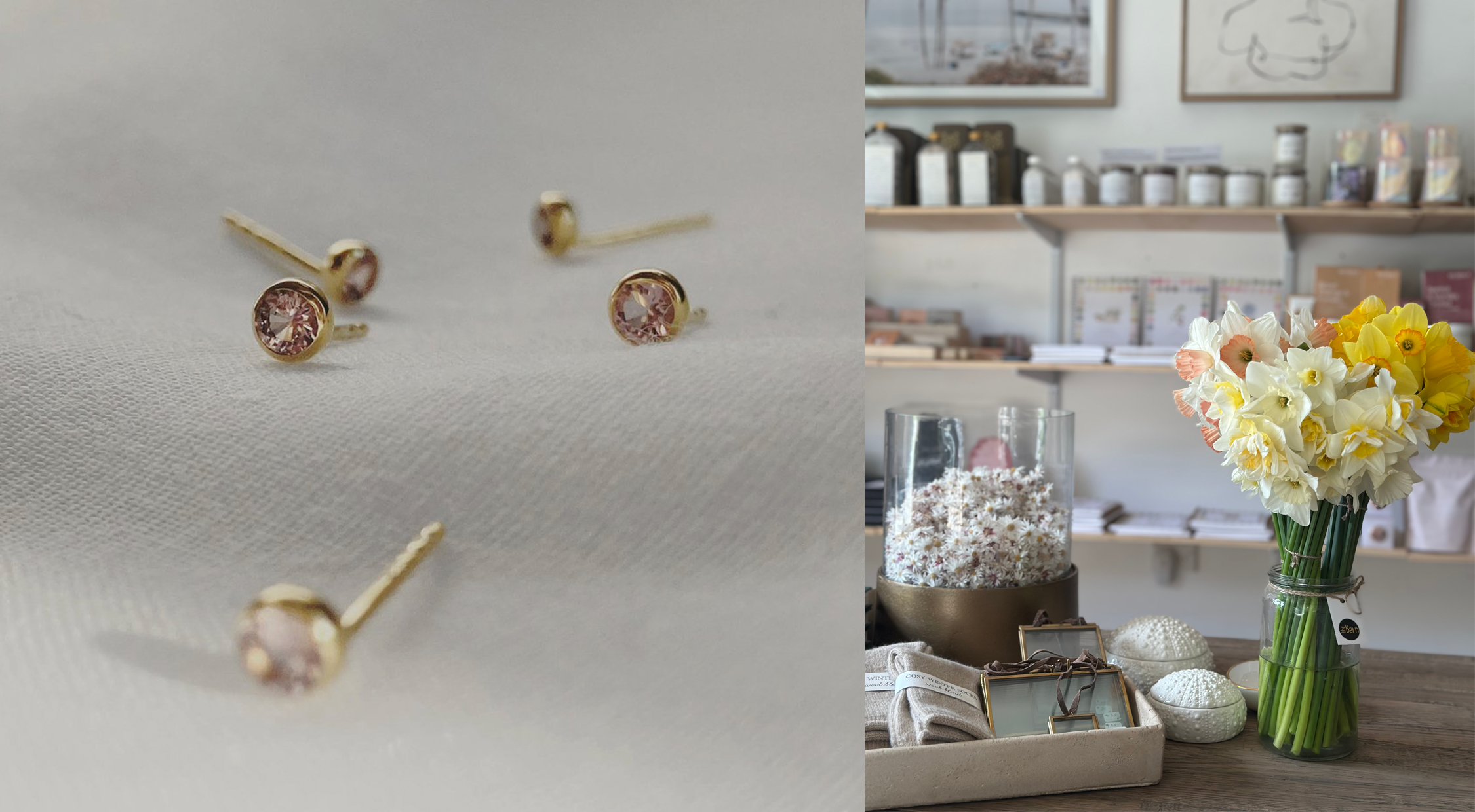 Jewelry earrings with pink gemstones displayed on a white cloth and a floral arrangement in a vase on a store counter at The Barn Giftshop