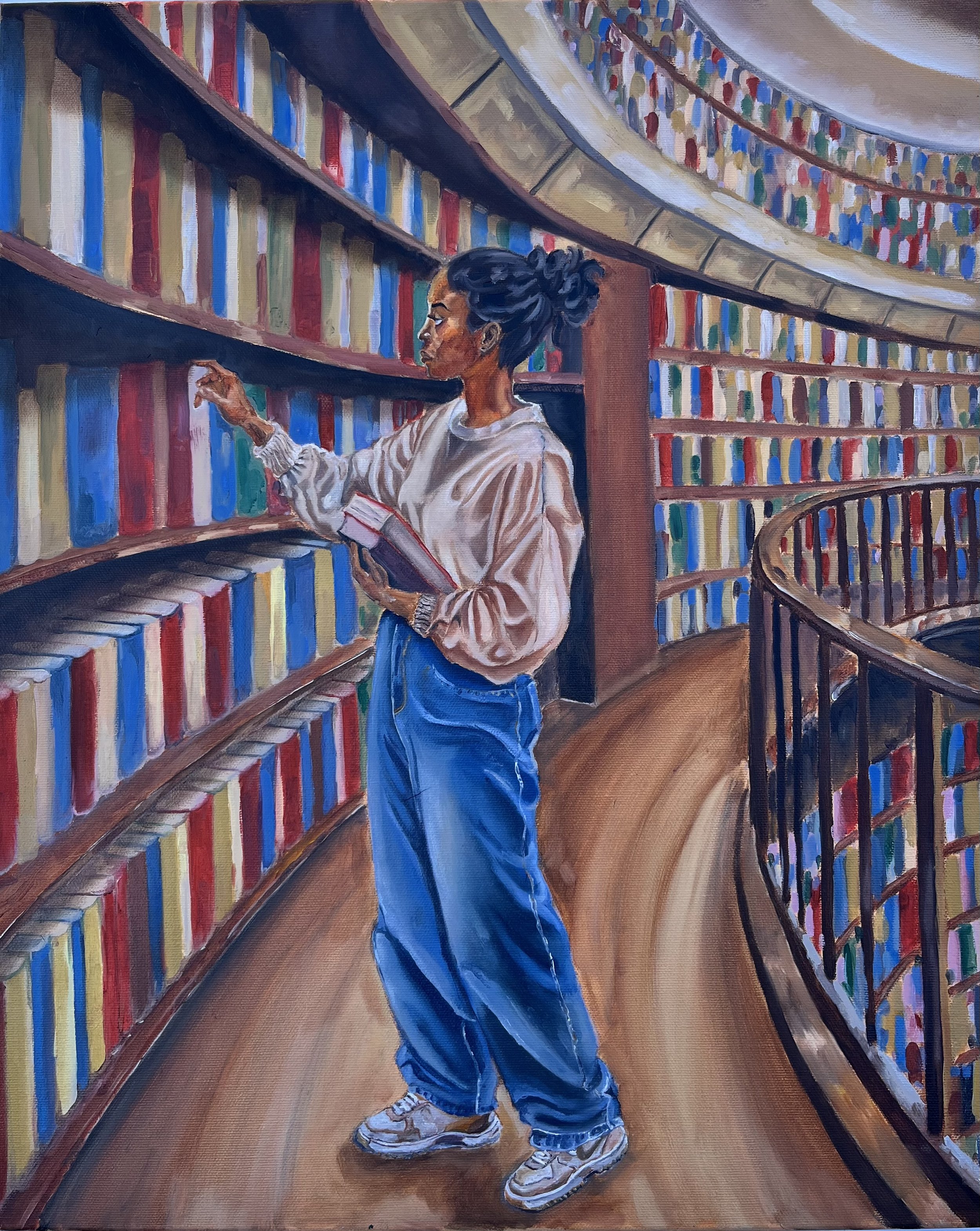 A young woman with dark hair styled in an updo wearing a beige sweater and blue jeans browsing books in a library with curved shelves filled with books.