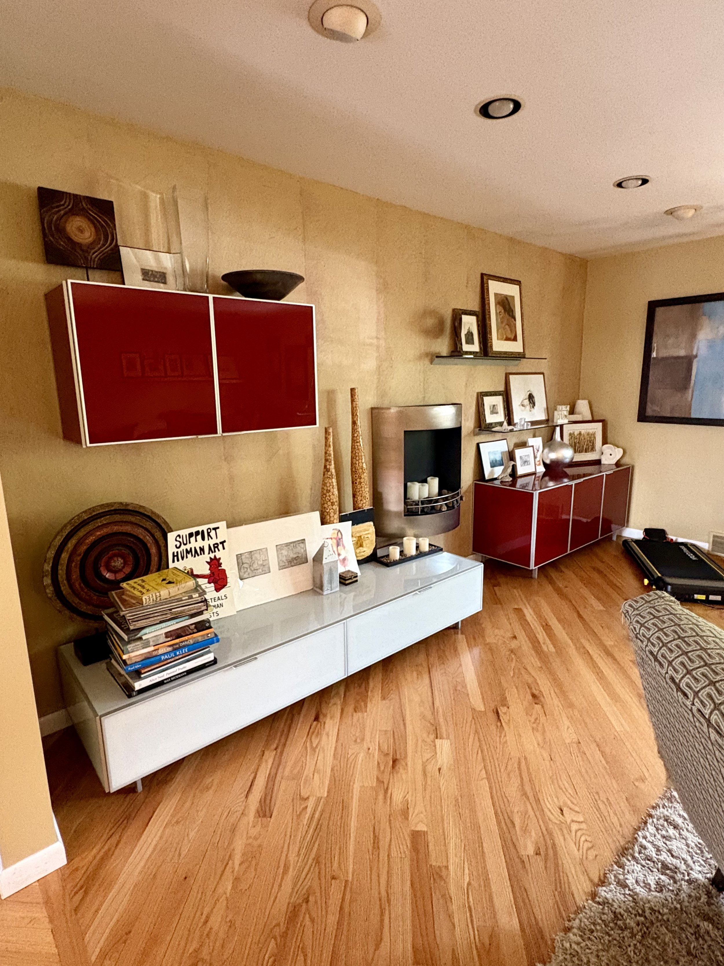 Before: This room was large with a gorgeous view, but the late 80's design drew all of the attention. We re-imagined this feature wall by removing the fireplace, and repainting the room a simple soft white to create a blank canvas