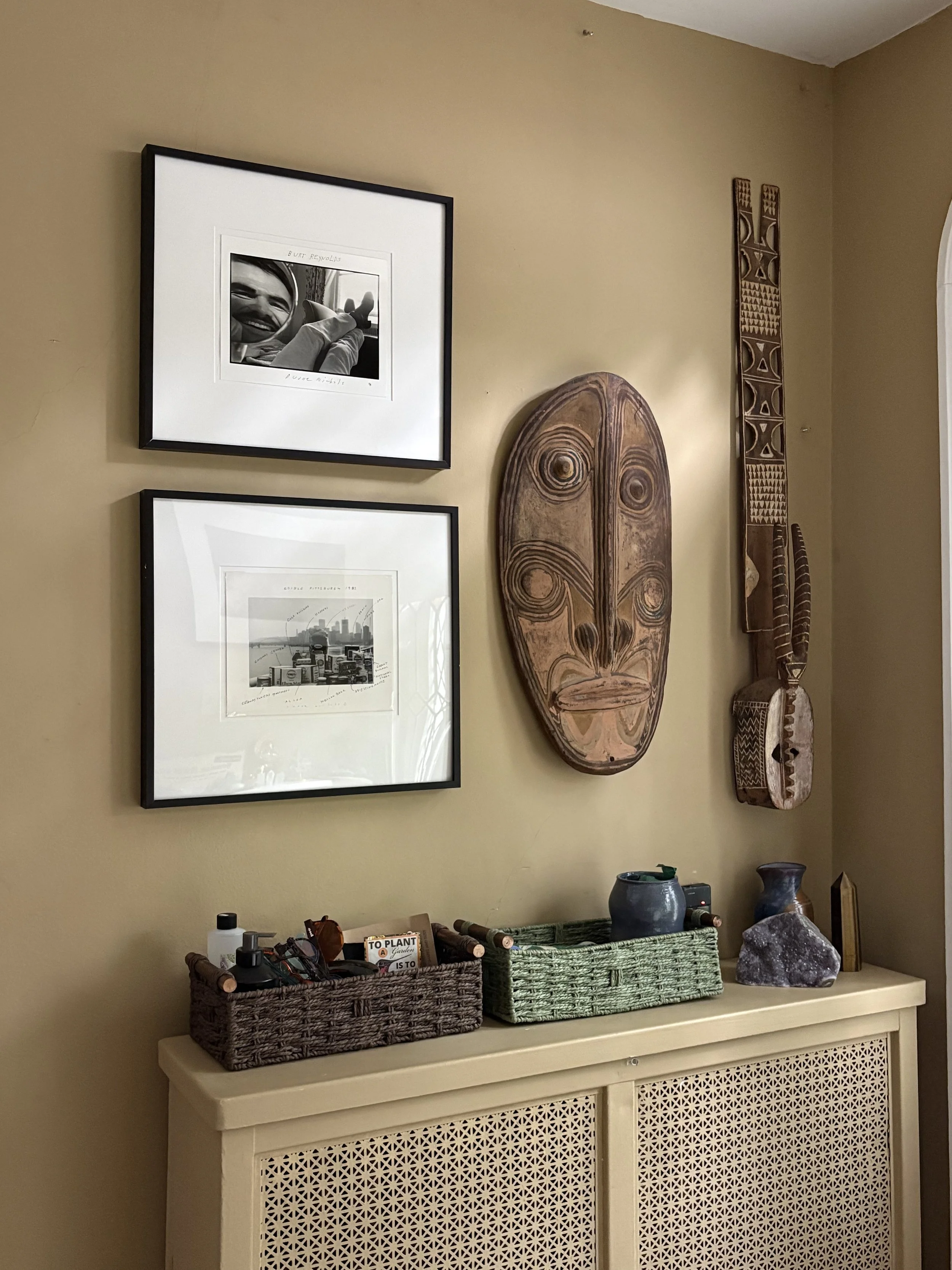 After: The artist had a few pieces of black and white photography and African art that didn't mix in well with the large scale modern wood paintings, but felt right at home in the entry, especially on the existing paint color. The lighter weight of t