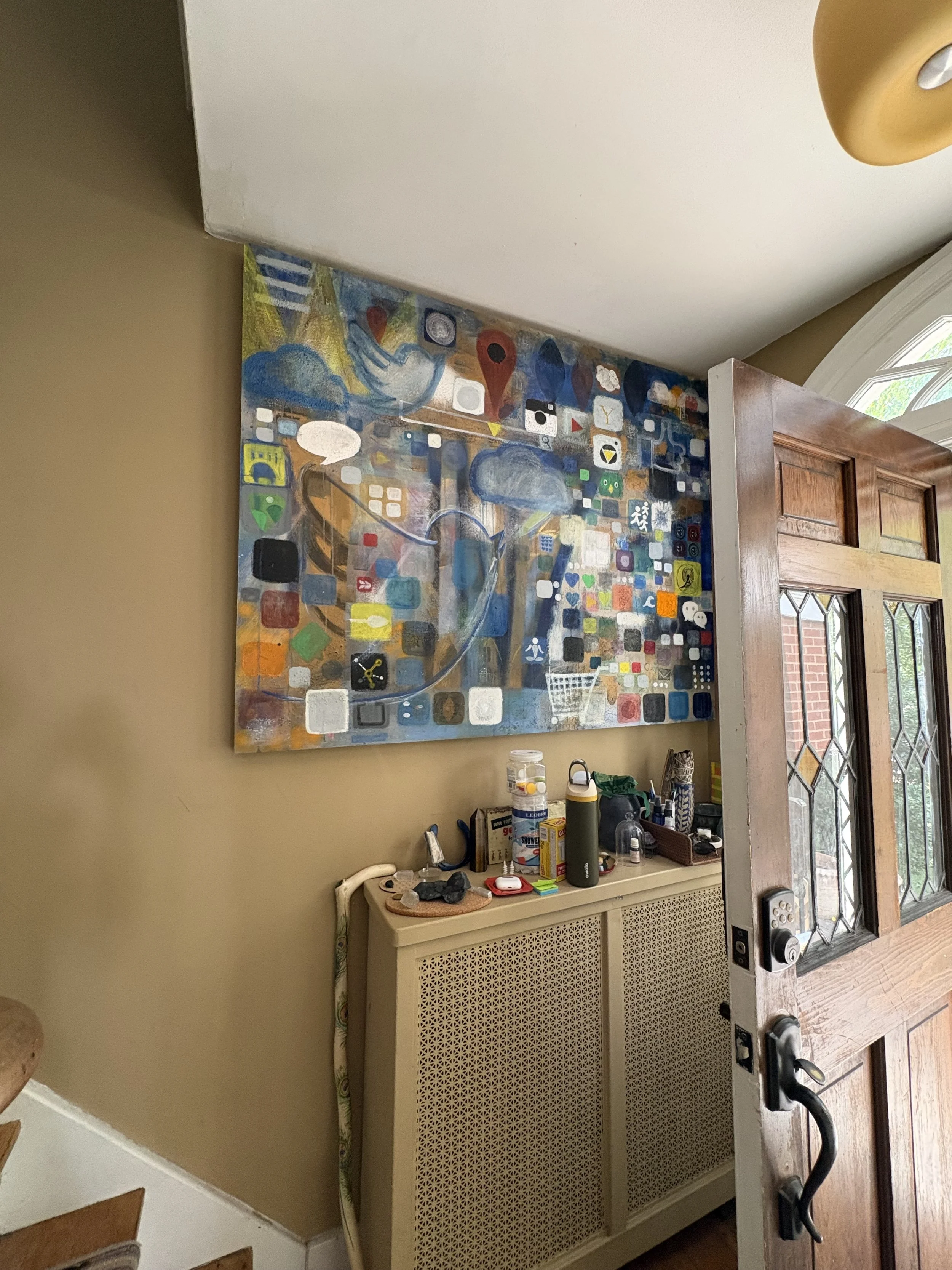 Before: Entries are natural landing places for clutter, so they need a plan for it. This piece of art is too large, too high up on the wall, and adds too much visual weight when entering the home