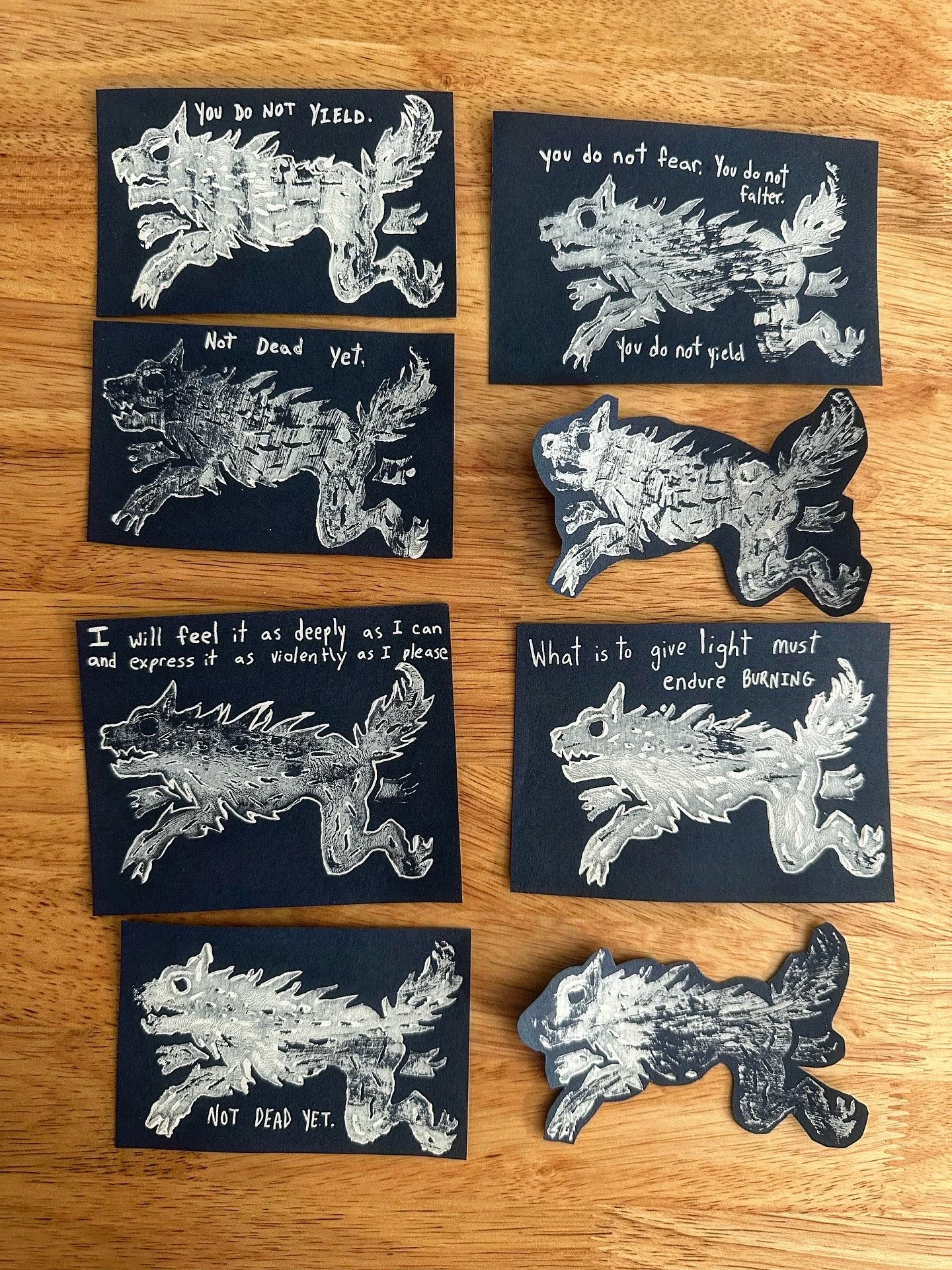 Linocut wolf designs I made cut out with text