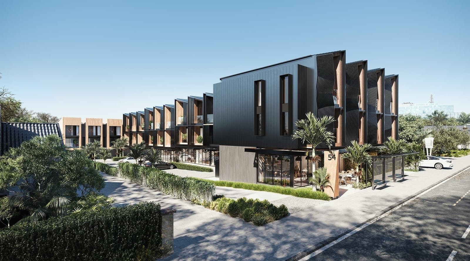 Modern multi-story apartment building with black and wood exterior, large windows, and landscaped surroundings with palm trees and greenery.