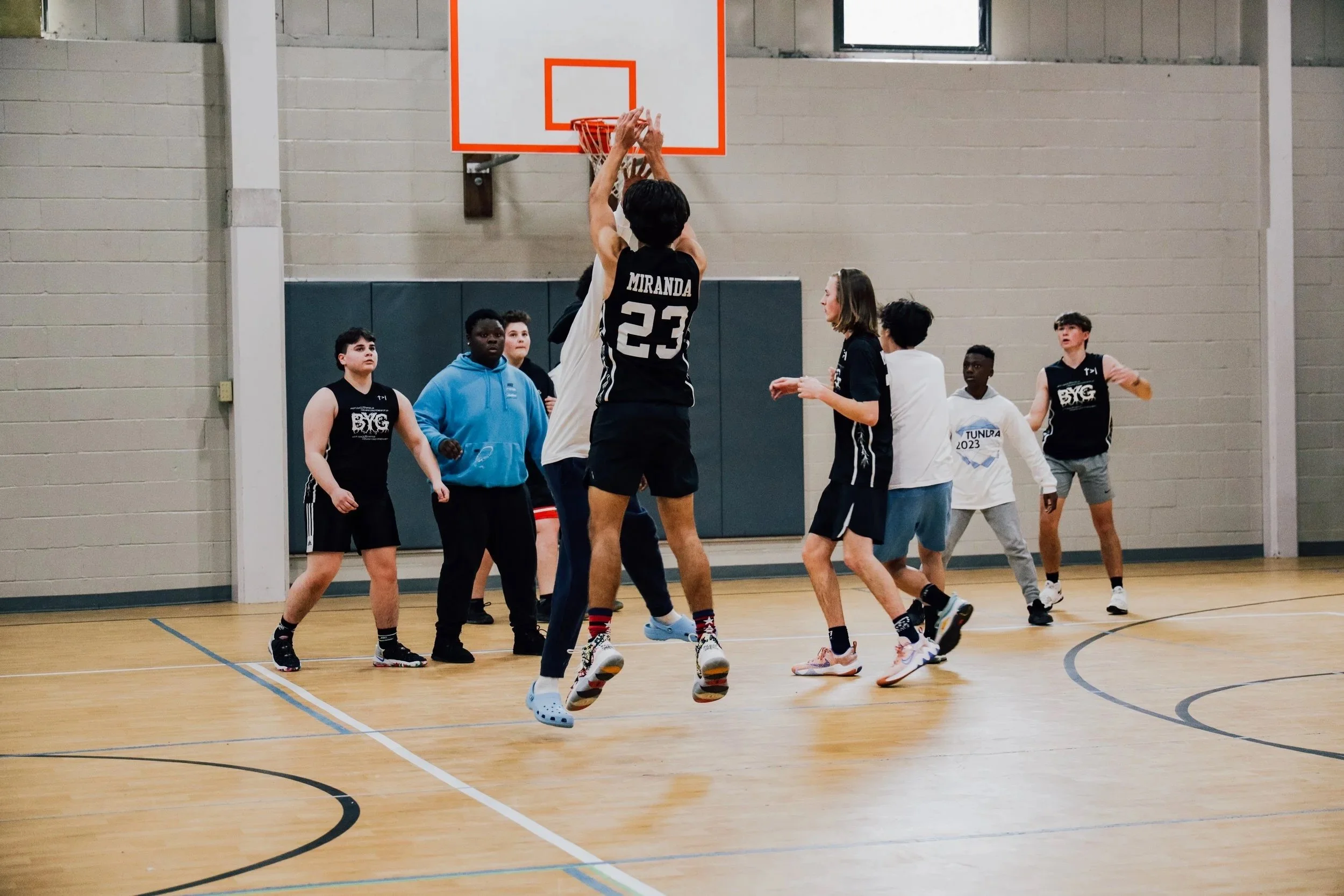 A group of young men playing basketball.