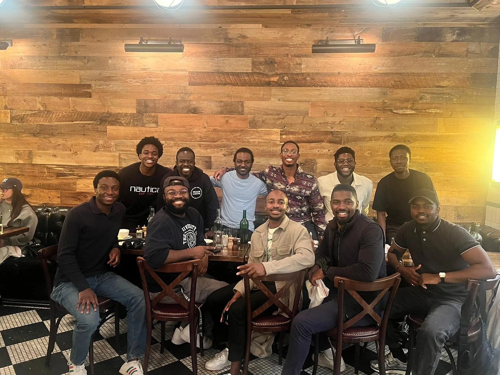 A group of Anchor Men members at dinner, smiling and posing for the camera.