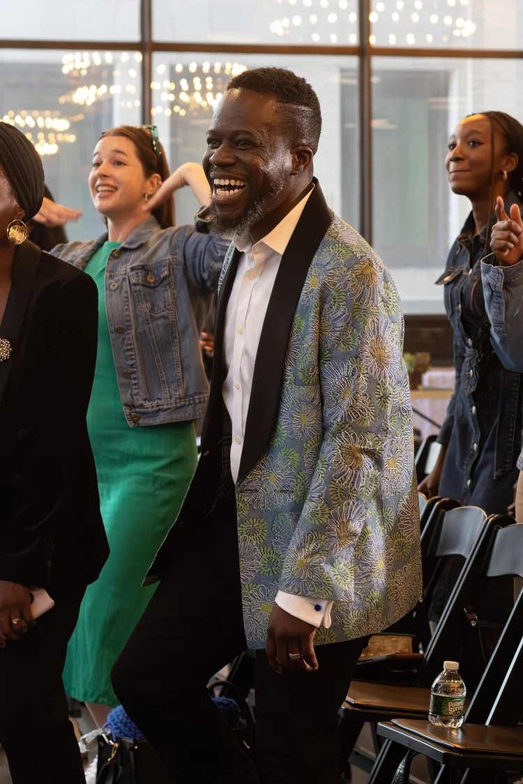 A few Ignite Church members laughing and smiling during a worship service.