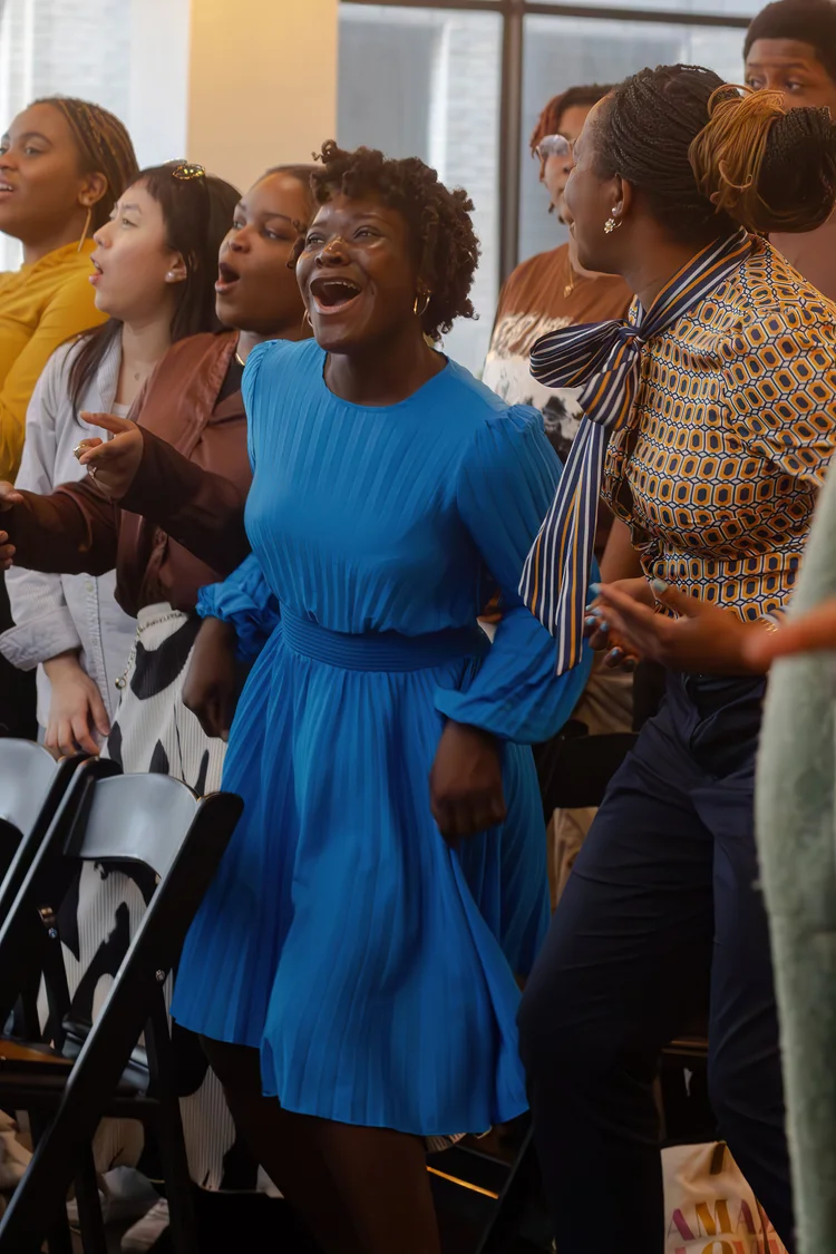 A group of Ignite members singing and jumping.