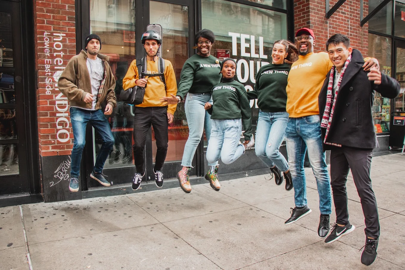A group of Ignite Church members laughing and jumping mid-air on a sidewalk.