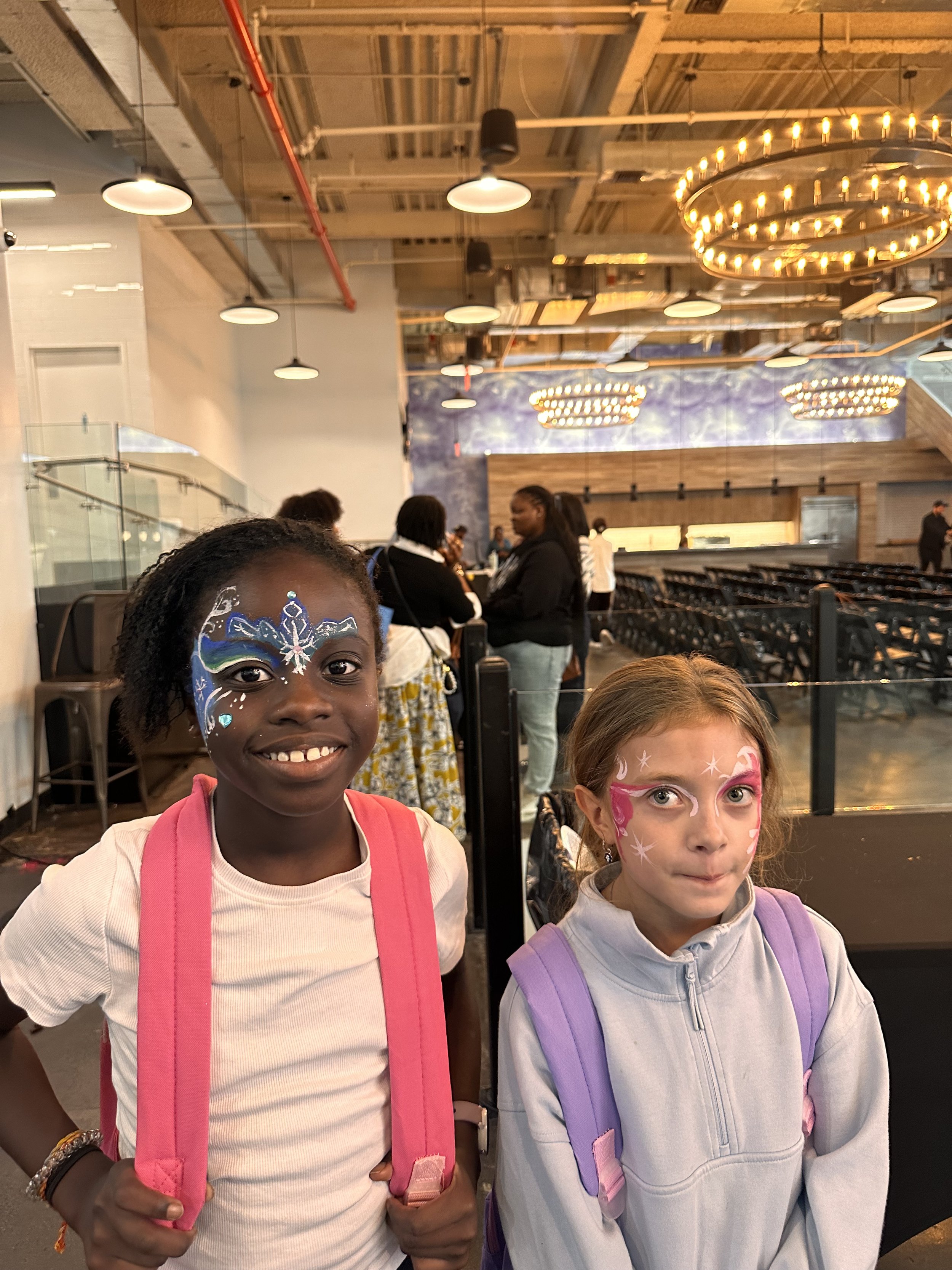 Two LiMO kids with painted faces after Easter service.