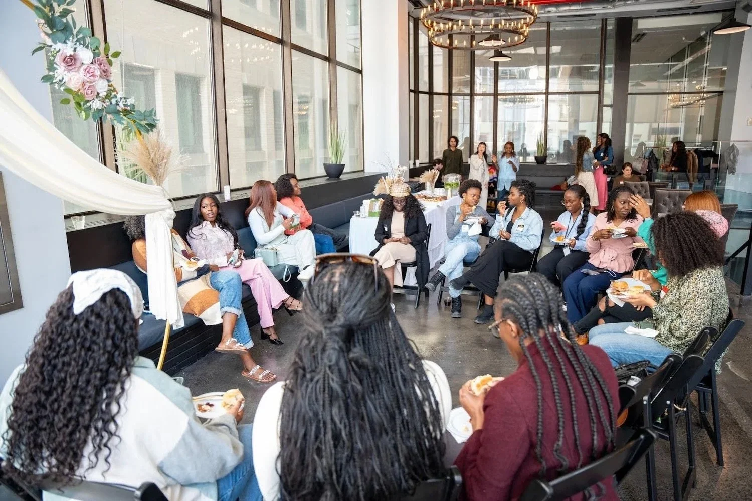 A large group of Whole Woman Conference attendees in discussion, seated in a circle.