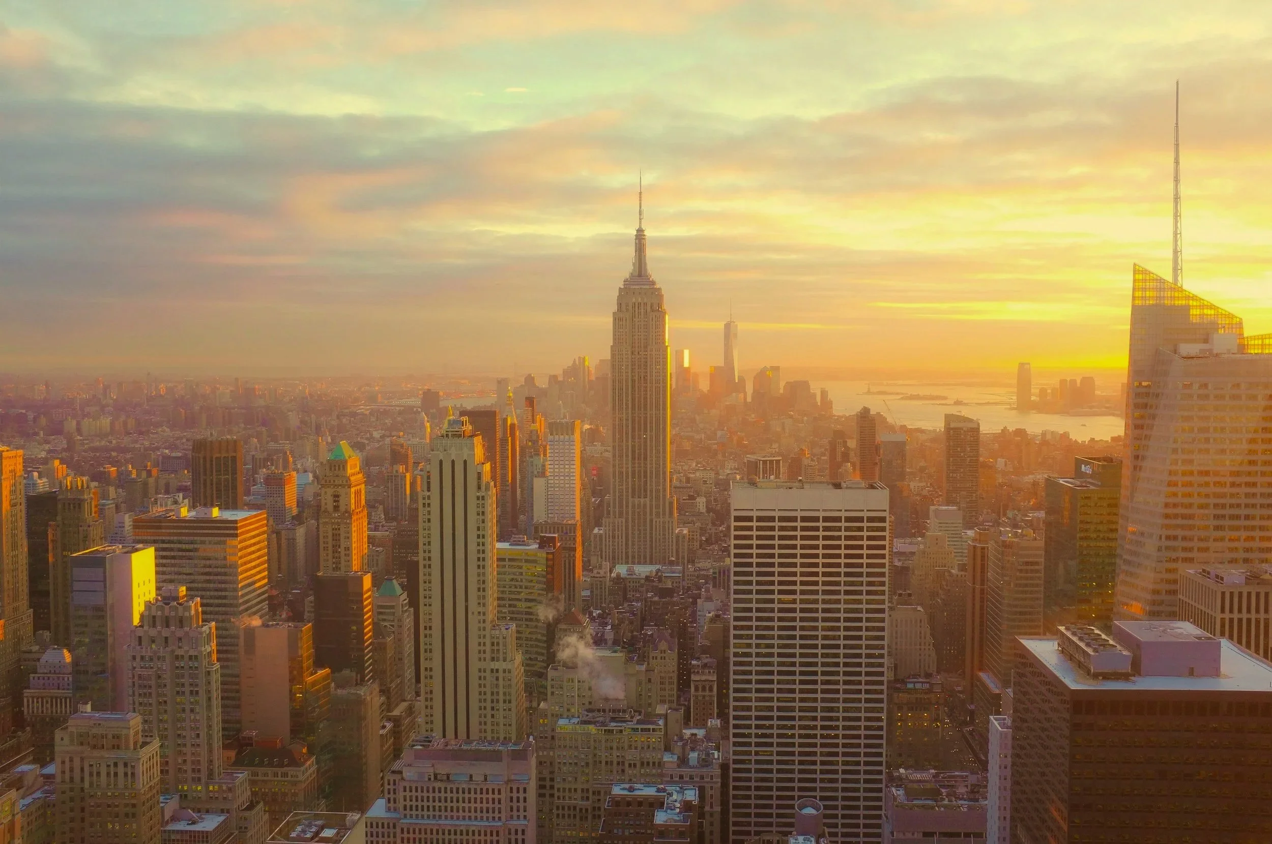 A view of the New York City skyline at dawn.