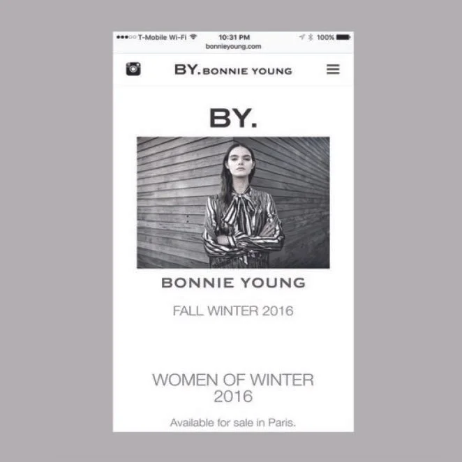 A mobile phone screen displaying a fashion website called "By Bonnie Young" with a black and white photo of a woman, promotional text for fall/winter 2016 collection, and the note that it's available for sale in Paris.
