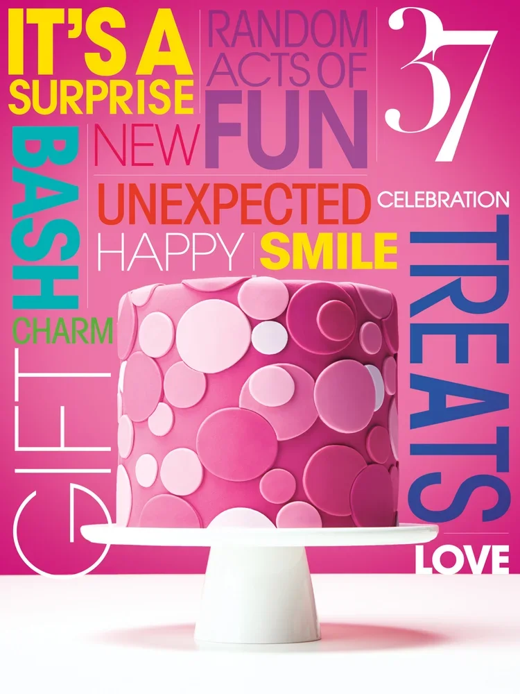 Colorful birthday cake with pink and purple circles on a white cake stand, set against a vibrant background with words like 'surprise,' 'fun,' 'smile,' and 'love' in bright colors.
