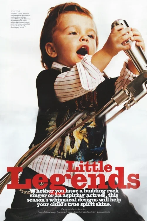 Young girl singing into a microphone with a telescope, wearing a graphic t-shirt and striped shirt sleeves, on the cover of Little Legends magazine.